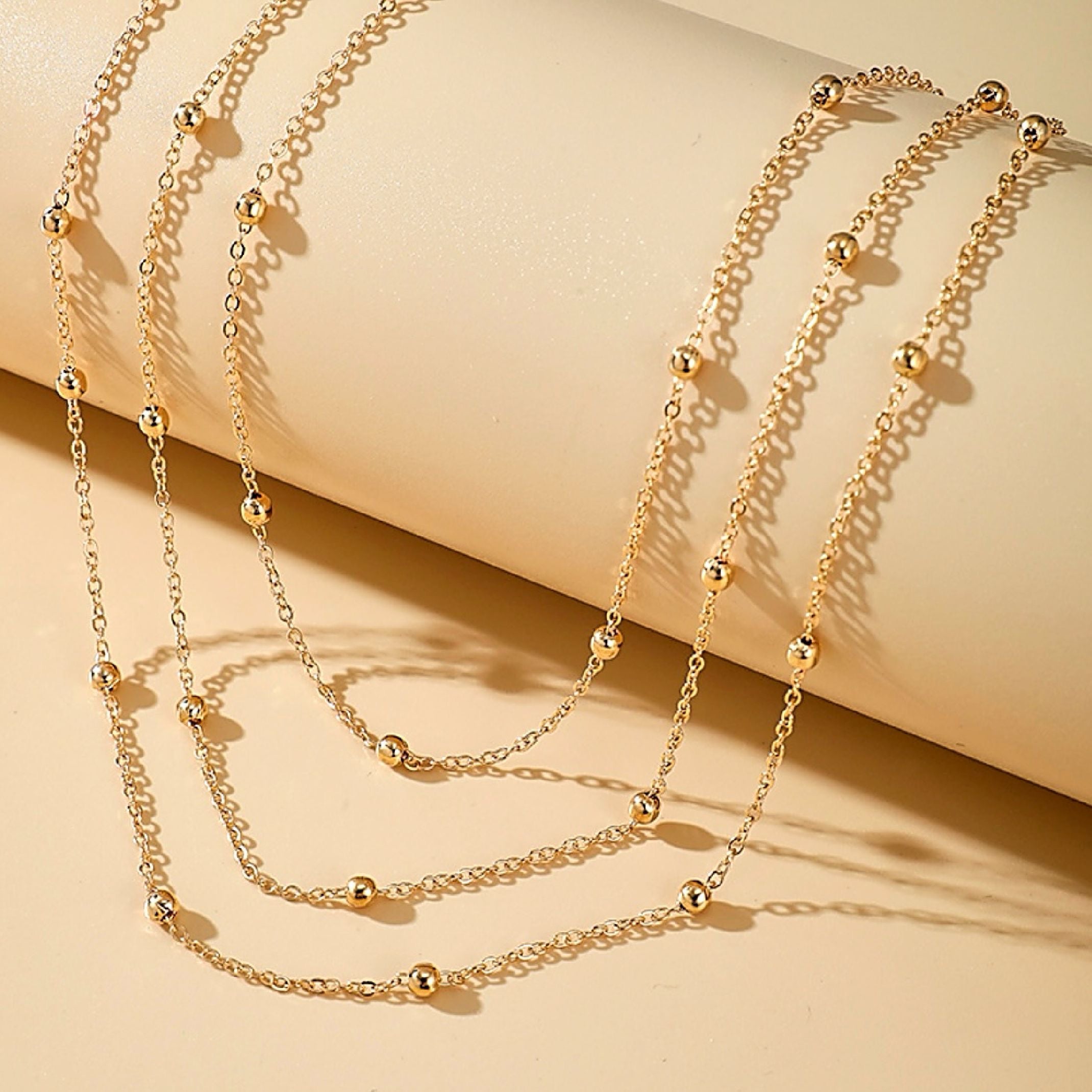 Gold bead chains layered 