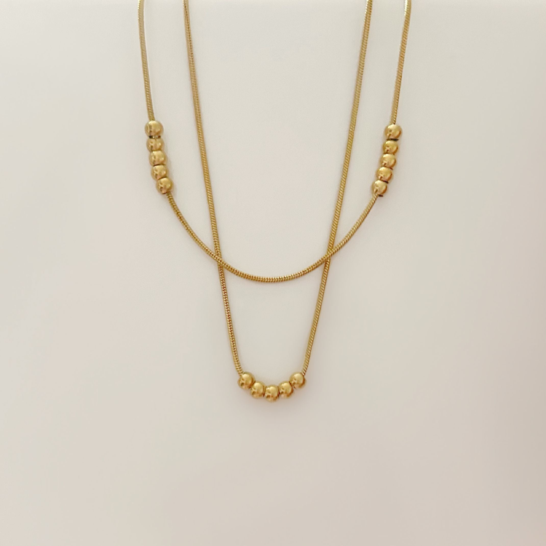 Gold bead layered necklace