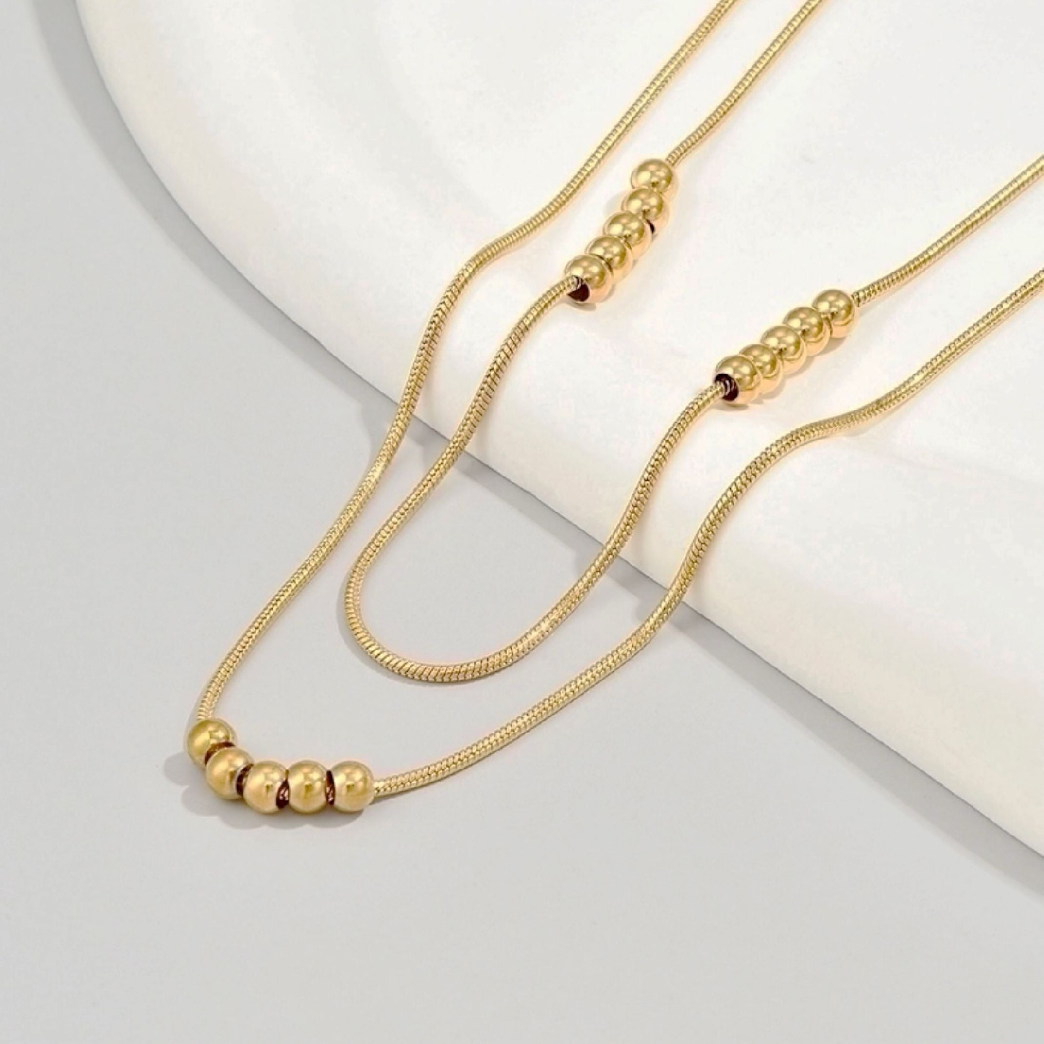 Gold bead layered necklace