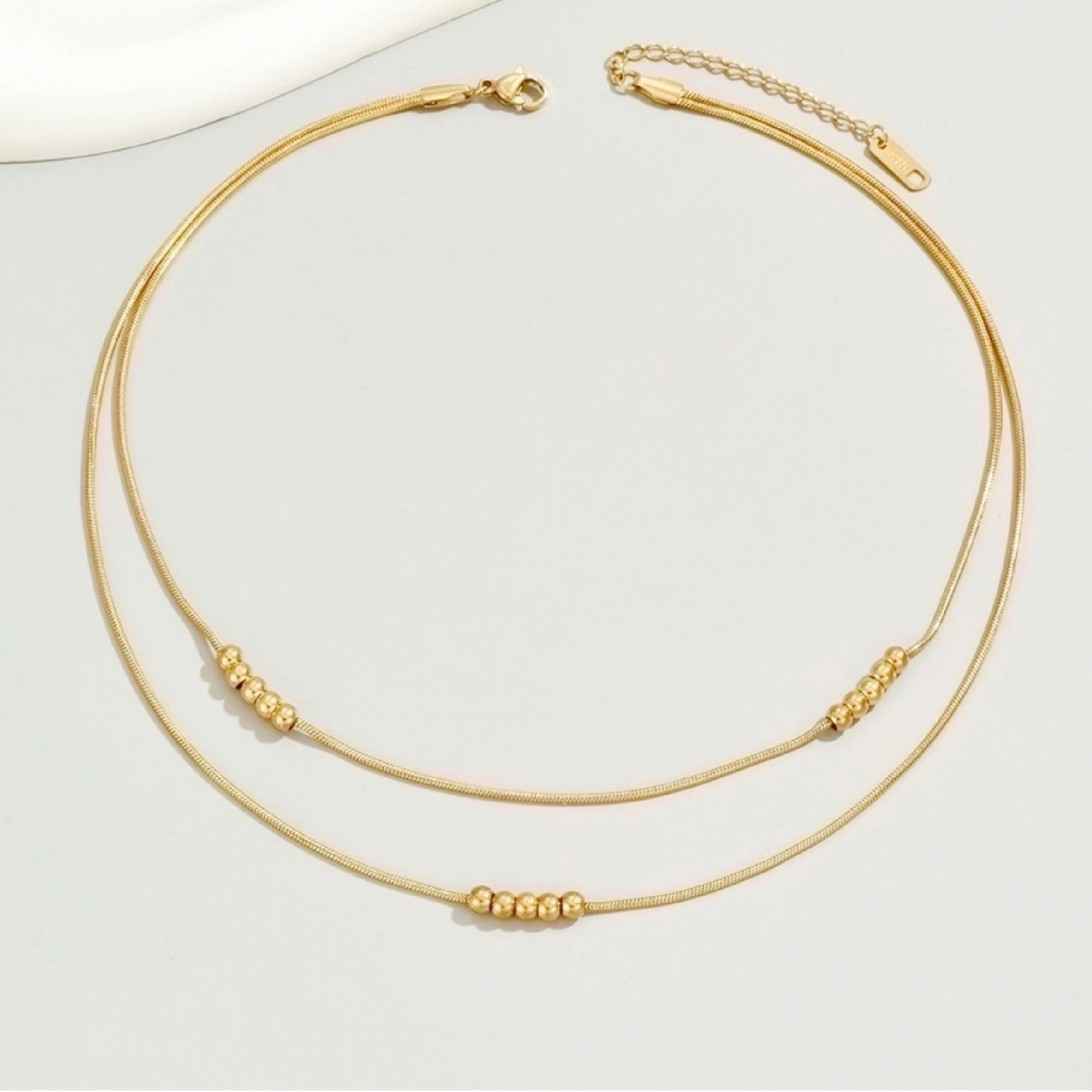 Gold bead layered necklace