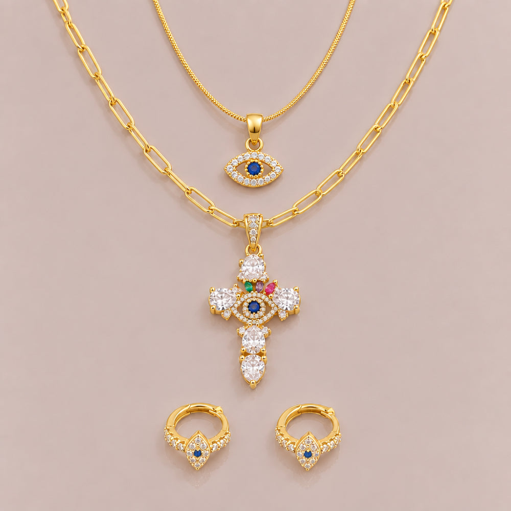Gold plated cross necklace, evil eye pendant necklace and huggie earrings with navy blue eye details and sparkling embellishments 