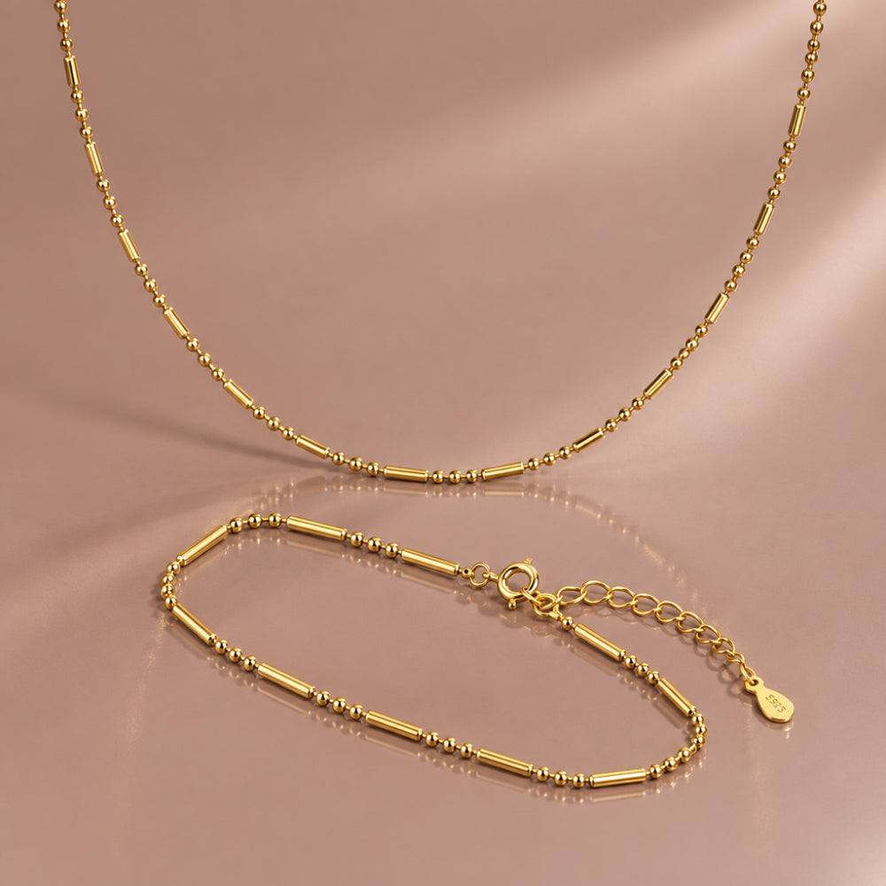 Delicate gold bead and bar necklace with matching bracelet 