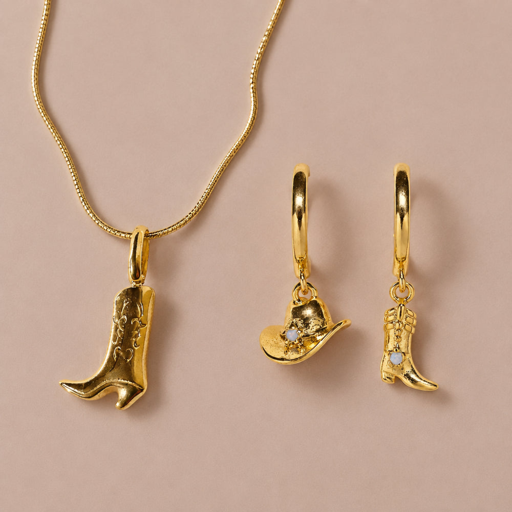Gold cowboy boot pendant necklace with matching cowboy hat and boot huggie earrings.