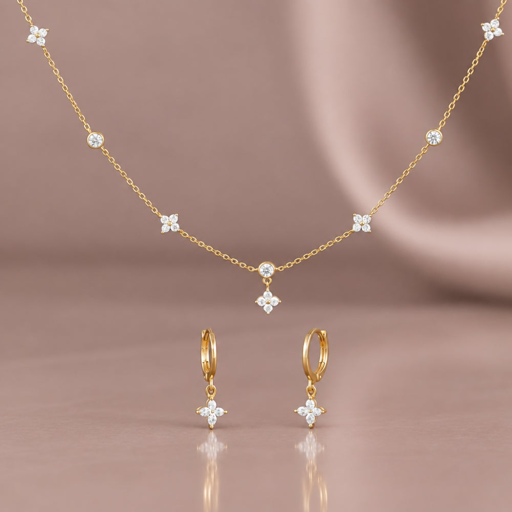 Gold plated flower necklace and matching flower stop huggie earrings with sparking cubic zirconia and Czech crystal details 