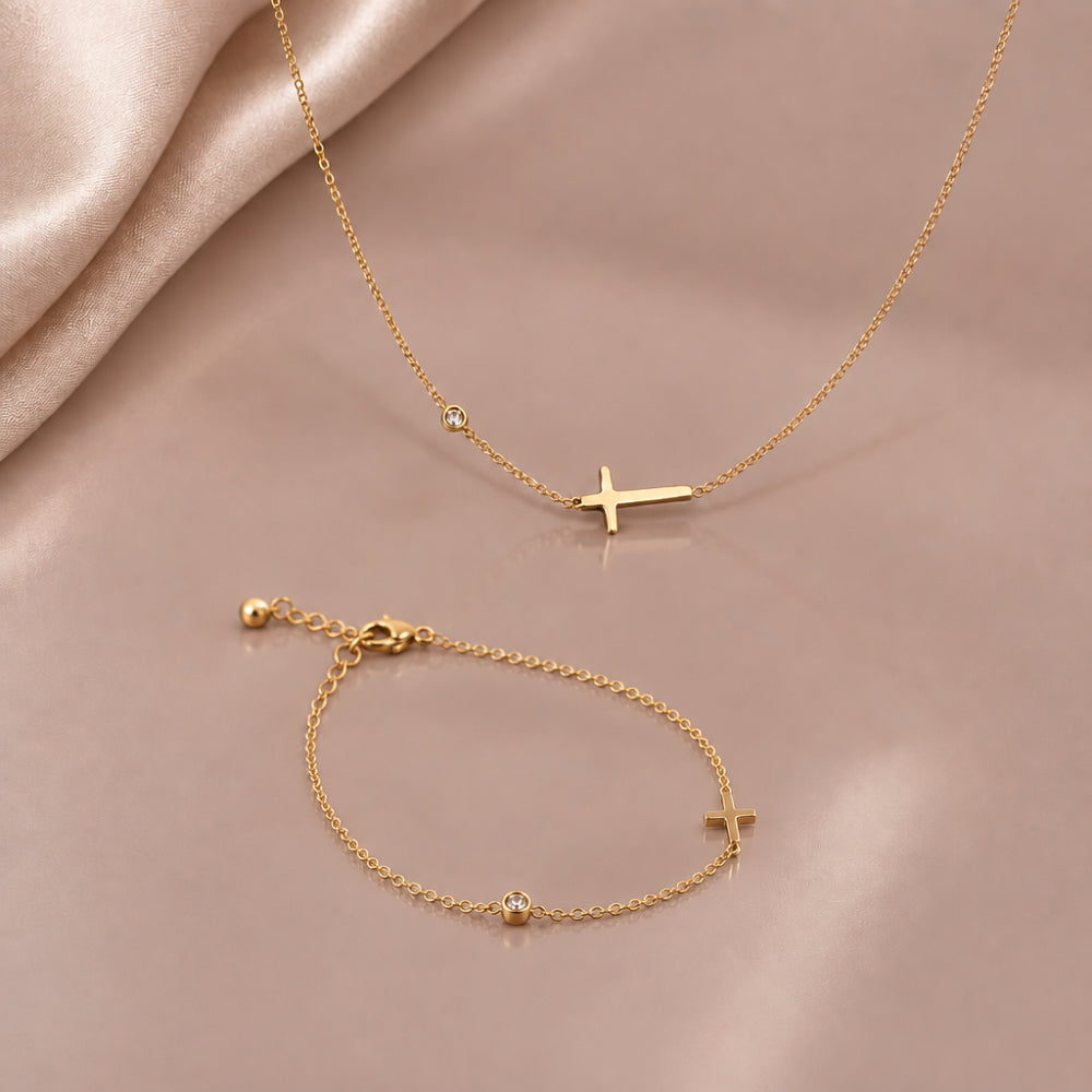 Gold tone dainty cross necklace and bracelet with horizontal cross details and cubic zirconia accents 