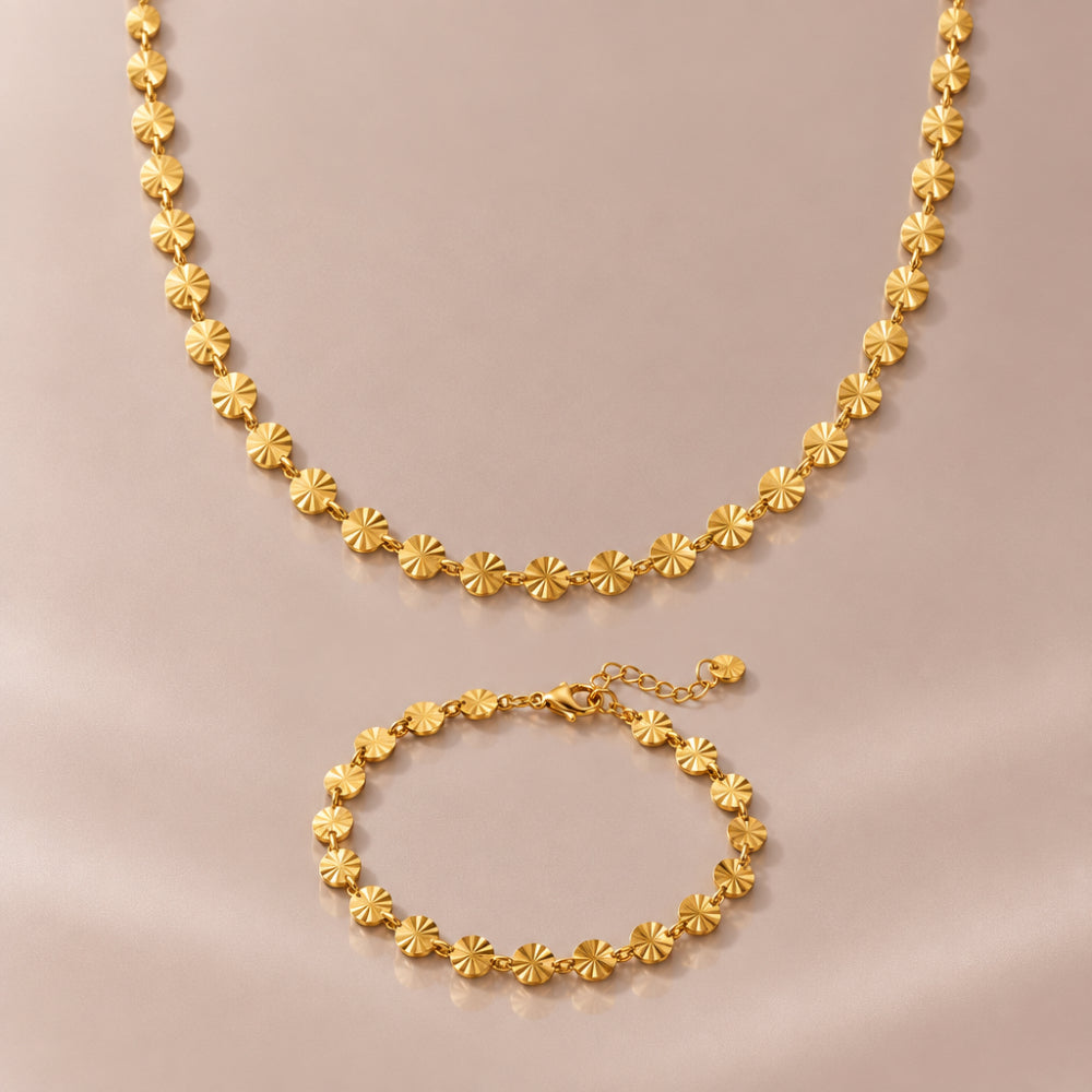 Gold sunburst disc necklace and matching bracelet with engraved disc details 