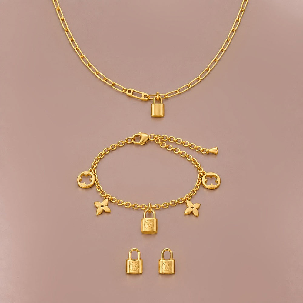 Gold Lock necklace, bracelet and stud earrings with matching lock motifs.