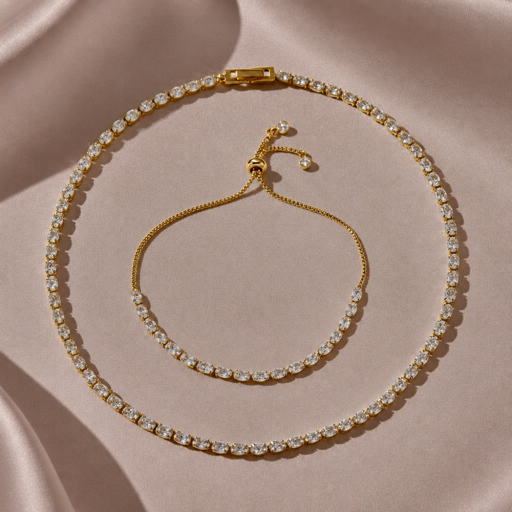 Gold tone tennis necklace and bracelet set with oval cut white cubic zirconia stones 