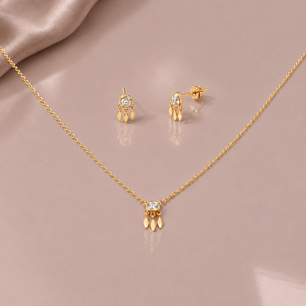 Dainty crystal pendant necklace and matching crystal stud earrings in gold tones. 