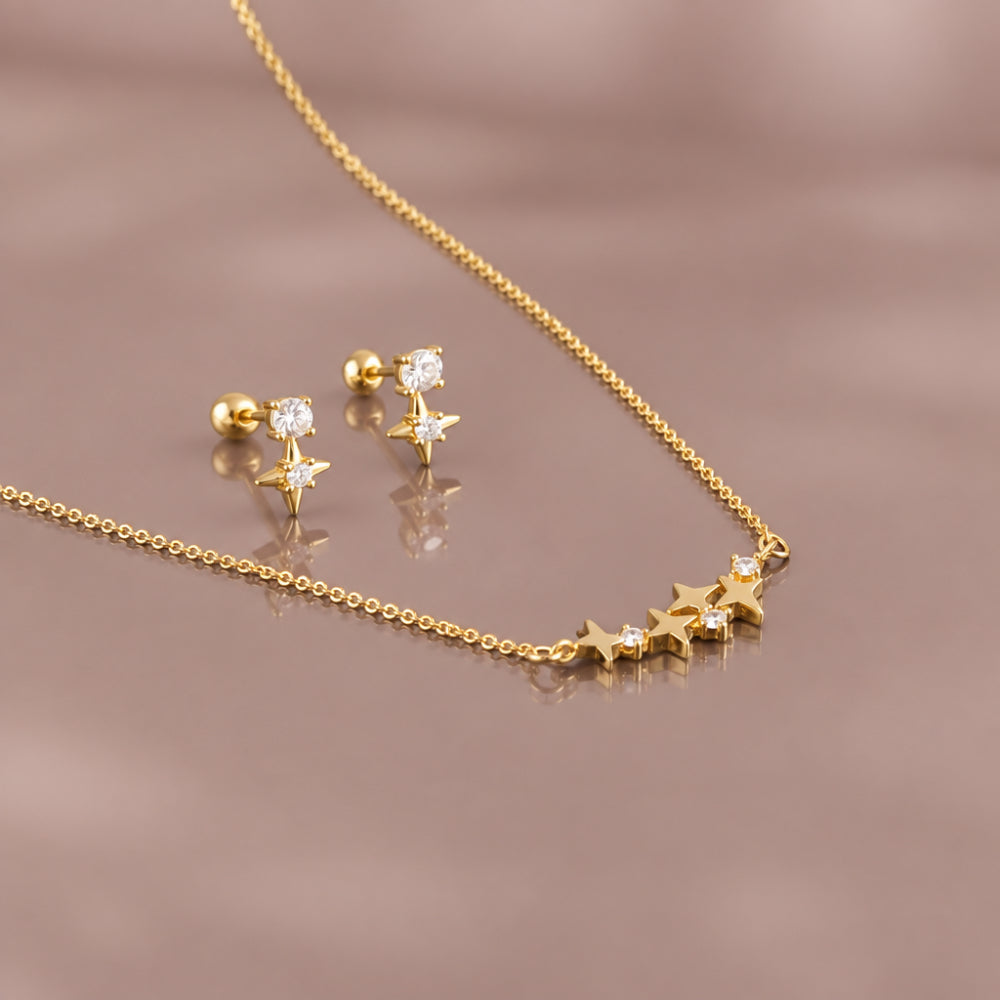 Gold star pendant necklace and matching crystal star stud earrings. 