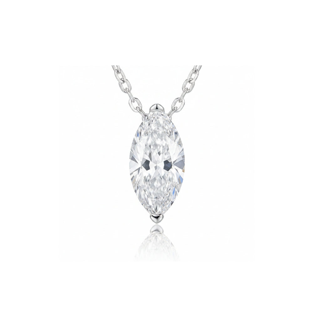A silver pendant necklace featuring a marquise-cut clear gemstone in a prong setting, suspended from a delicate silver chain against a white background with a soft reflection below.