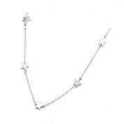 A delicate silver chain necklace featuring five small, evenly spaced star charms on a plain white background.