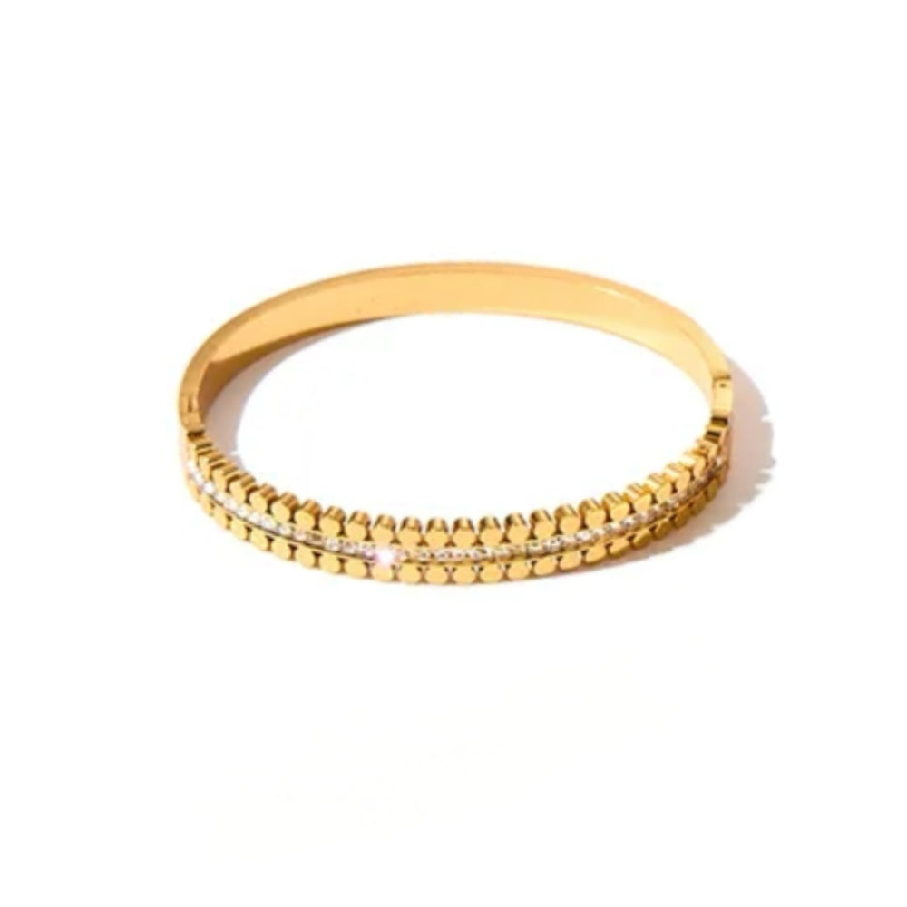 A gold-plated bangle bracelet featuring a textured beaded outer band and a central channel set with small clear stones, shown on a plain white background.