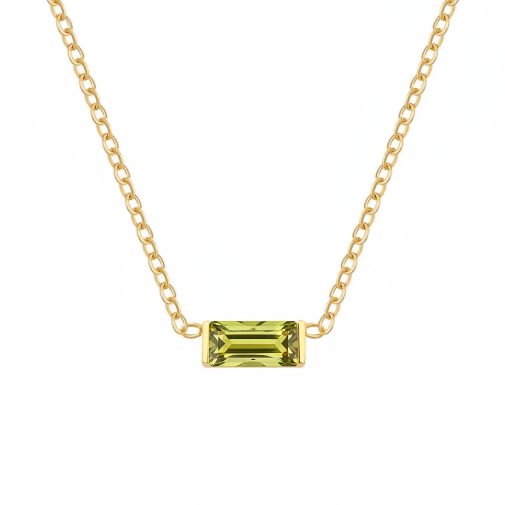 A delicate yellow gold chain necklace featuring a small rectangular emerald-cut olive green gemstone pendant, displayed against a solid white background.