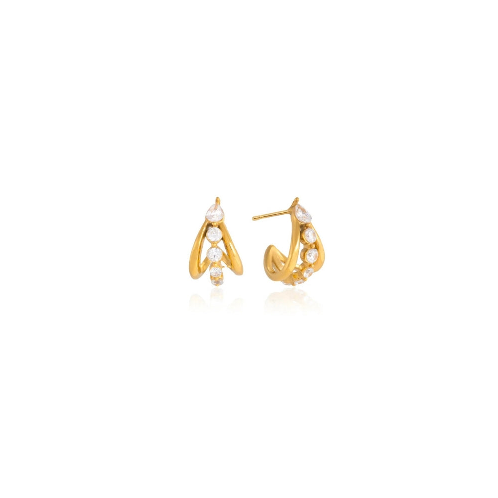 A pair of gold crescent-shaped hoop earrings with a vertical row of clear round-cut stones, displayed on a clean white background with a soft reflection.