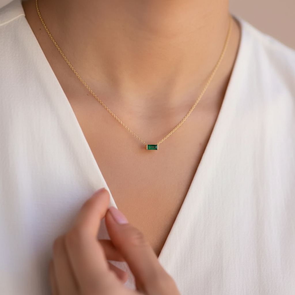 Green jewel on gold necklace 