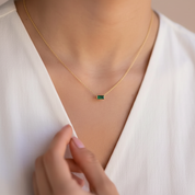 Green jewel on gold necklace 