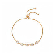 A delicate gold chain bracelet with five clear round-cut stones set in a row, featuring an adjustable sliding clasp, shown on a plain white background.