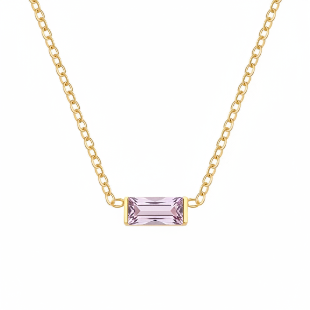 A delicate gold chain necklace featuring a small rectangular emerald-cut light purple gemstone pendant, displayed against a solid white background.