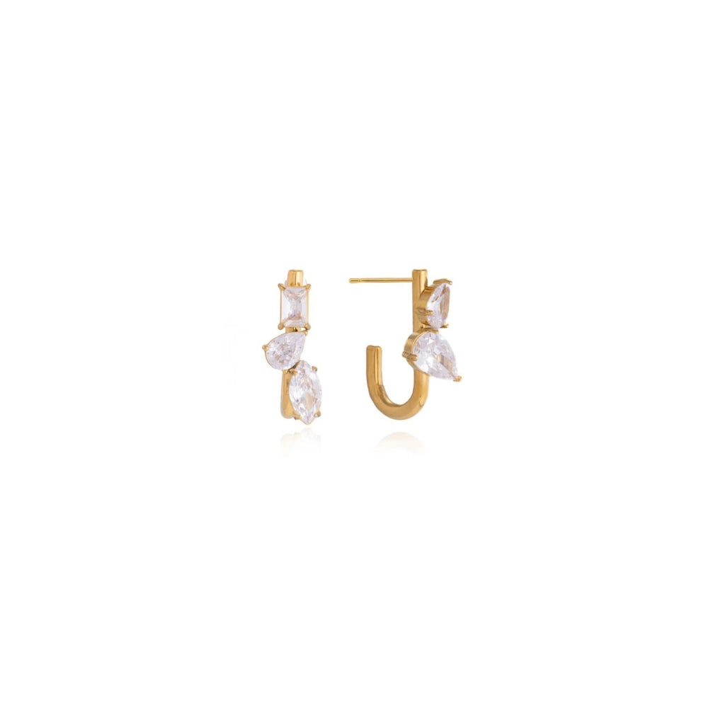 A pair of gold huggie hoop earrings decorated with clear marquise and rectangular gemstones, displayed on a clean white background.