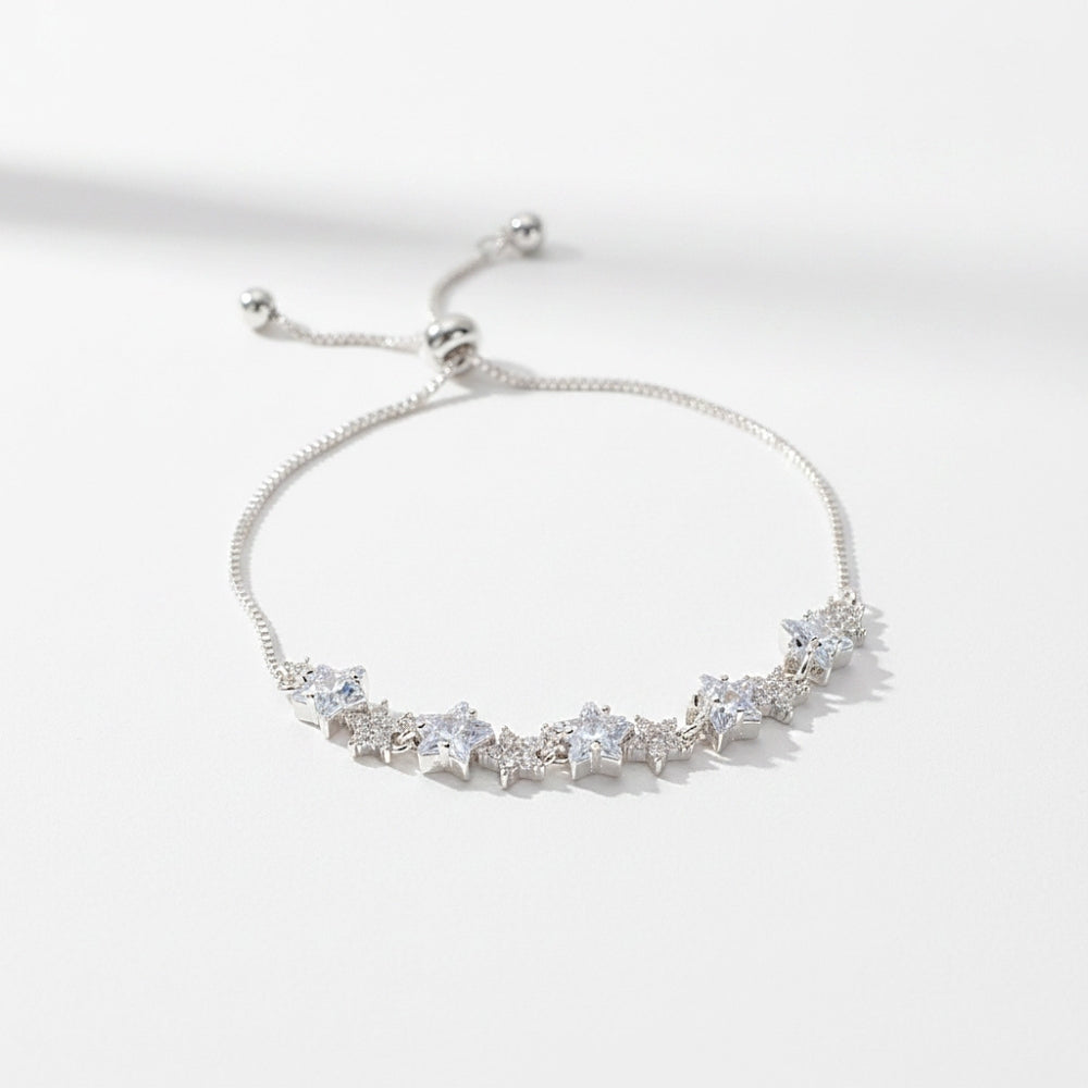 A silver adjustable chain bracelet featuring a row of clear star-shaped crystals, photographed on a clean white background with soft shadows.