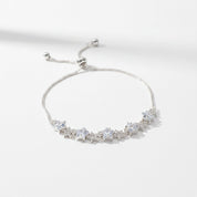A silver adjustable chain bracelet featuring a row of clear star-shaped crystals, photographed on a clean white background with soft shadows.