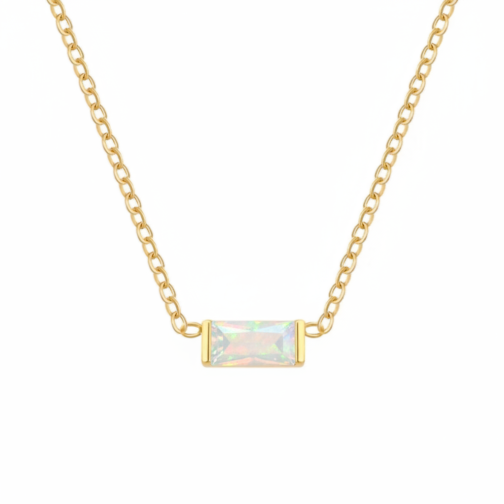 A delicate gold chain necklace featuring a small rectangular bezel-set iridescent opal pendant, shown against a plain white background.