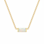 A delicate gold chain necklace featuring a small rectangular bezel-set iridescent opal pendant, shown against a plain white background.