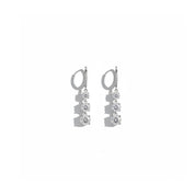 A pair of silver drop earrings with three clear gemstones in each earring, displayed against a solid white background.