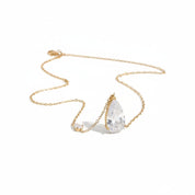 A gold chain necklace featuring a teardrop-shaped clear gemstone pendant and a smaller matching clear gemstone charm, displayed on a clean white background.