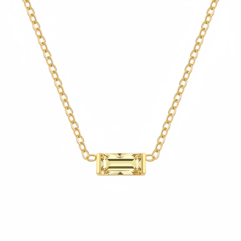 A gold chain necklace featuring a rectangular emerald-cut yellow gemstone pendant, shown against a plain white background.