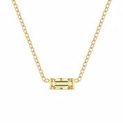 A gold chain necklace featuring a rectangular emerald-cut yellow gemstone pendant, shown against a plain white background.