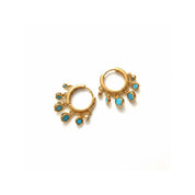 A pair of gold huggie hoop earrings with dangling turquoise blue gemstone accents, displayed on a clean white background.