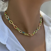 Colorful chain necklace worn by a person against a white background