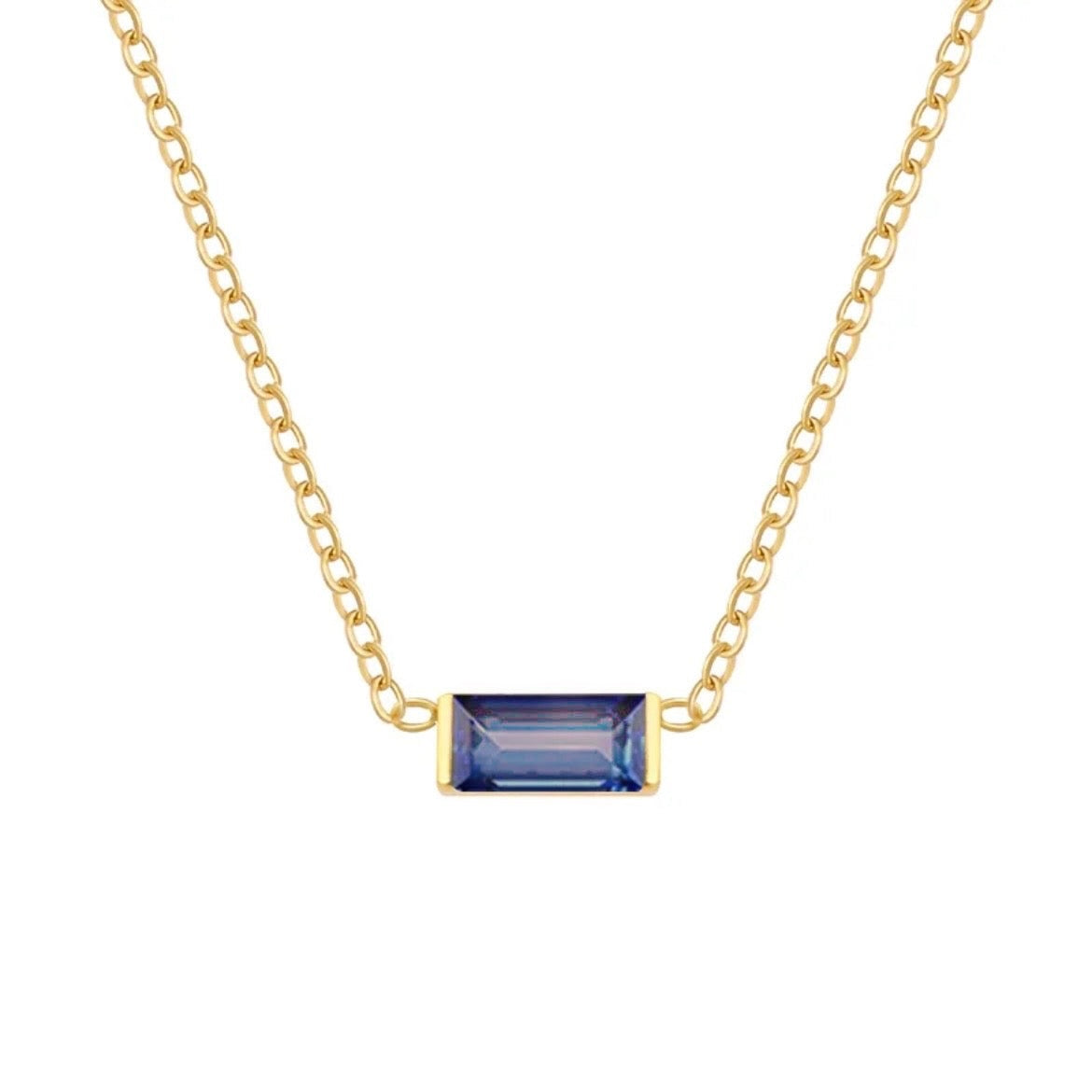 A delicate gold chain necklace featuring a rectangular baguette-cut blue gemstone pendant in a gold bezel setting, shown against a plain white background.