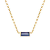 A delicate gold chain necklace featuring a rectangular baguette-cut blue gemstone pendant in a gold bezel setting, shown against a plain white background.