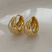 Chunky gold huggie hoop earrings with diamond stars 