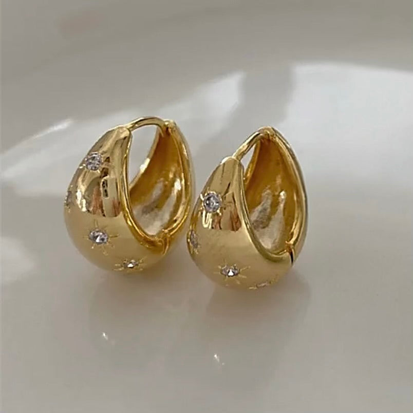 Chunky gold huggie hoop earrings with diamond stars 