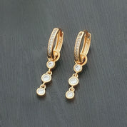 Diamond drop gold huggie earrings 