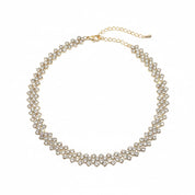 A gold-toned choker necklace adorned with multiple rows of clear rhinestones, featuring a matching gold chain extender and clasp, shown on a plain white background.