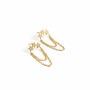 A pair of gold dangle earrings featuring three star-shaped studs connected by delicate chains, shown on a plain white background.
