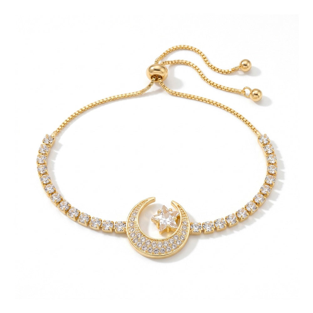 A delicate gold-toned bracelet with a crescent moon and star motif, adorned with small clear stones, shown against a white background 