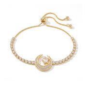 A delicate gold-toned bracelet with a crescent moon and star motif, adorned with small clear stones, shown against a white background 