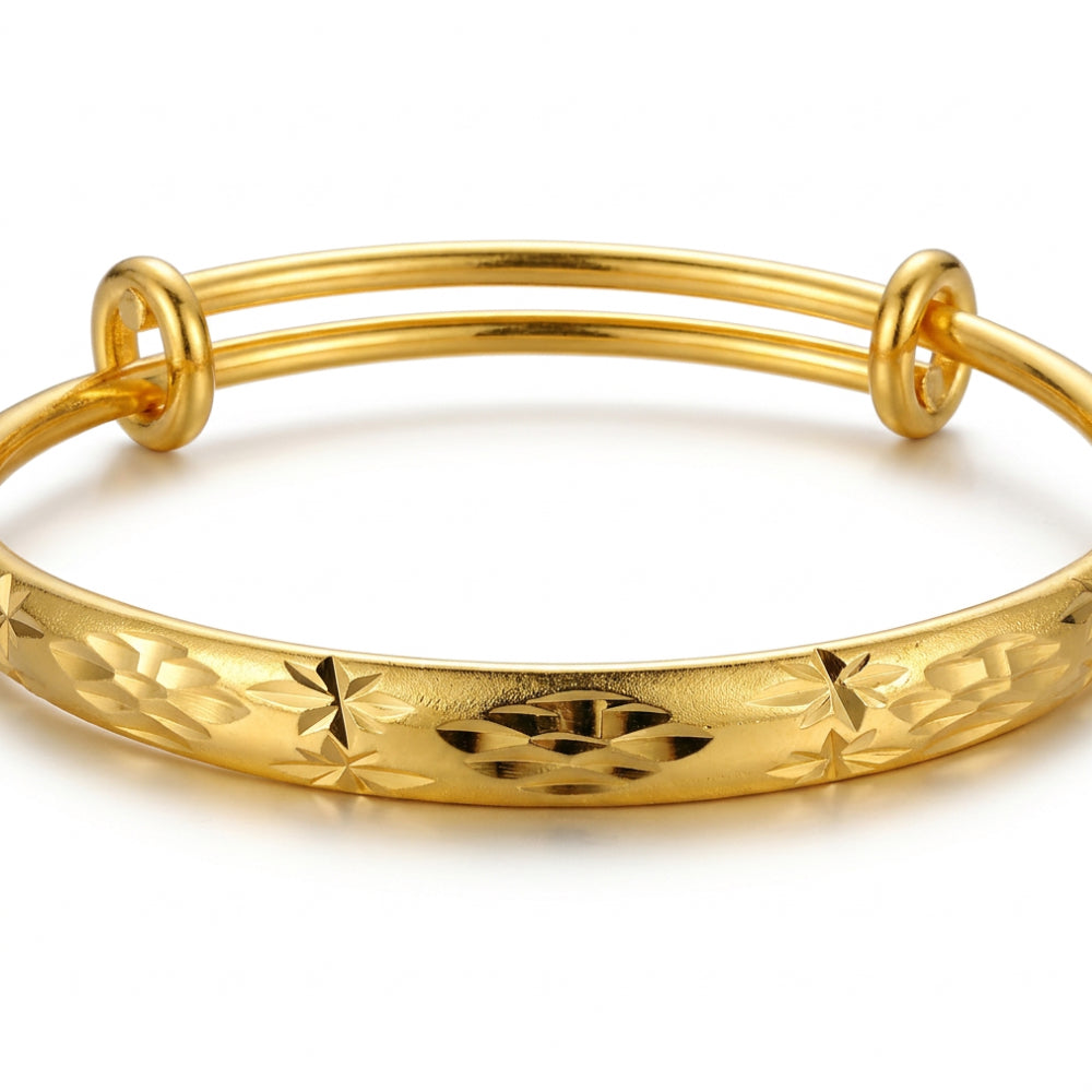 A gold-plated double-strand bangle bracelet with a textured, star-patterned outer band, shown on a clean white background.