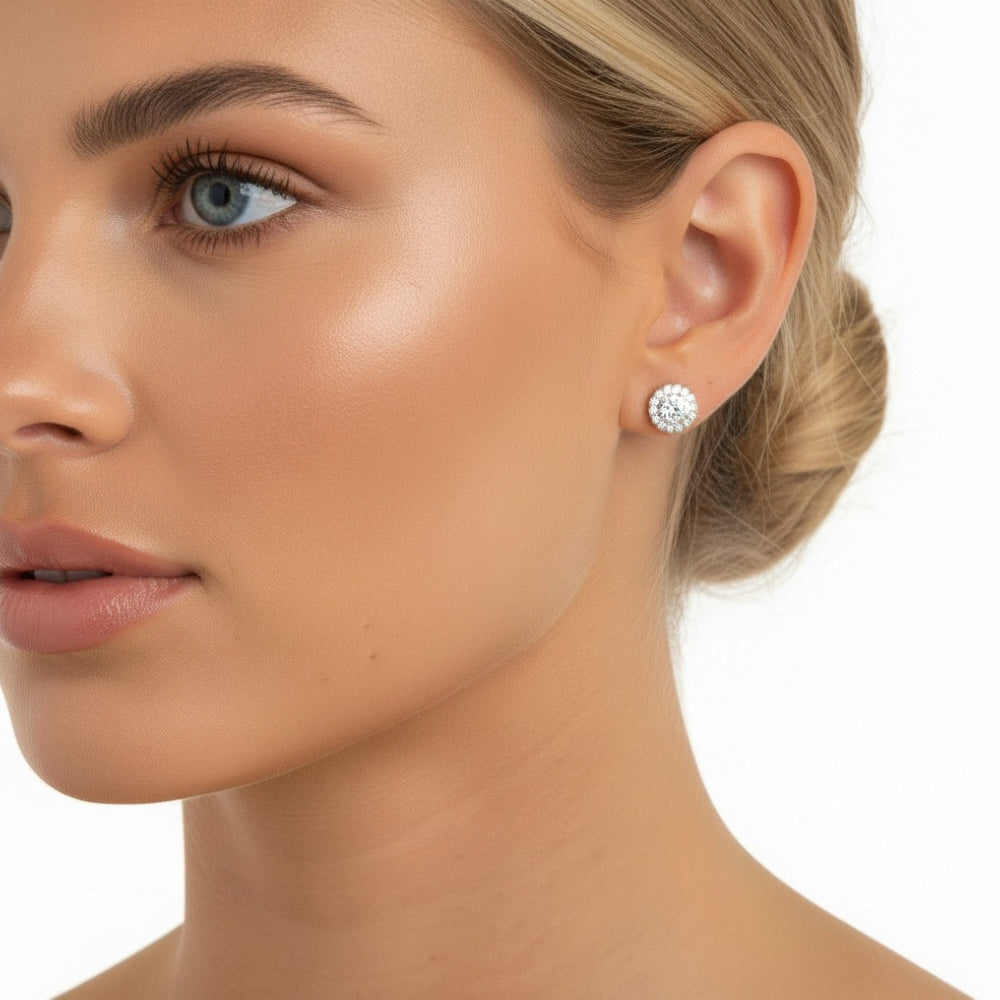 Woman wearing sparkling diamond stud earrings in silver 