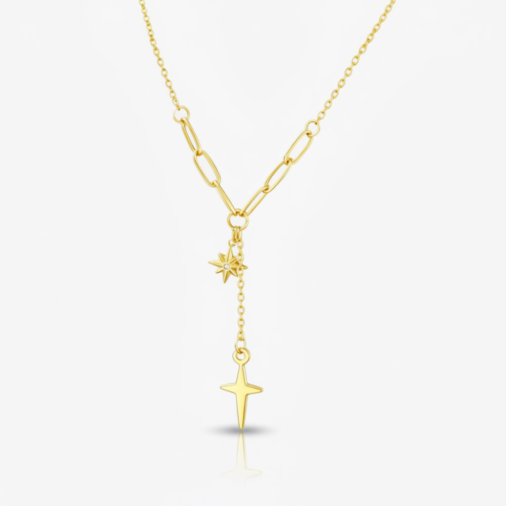 A gold Y-necklace featuring a paperclip chain, a small starburst charm, and a larger dangling star pendant, shown on a light gray background.