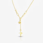 A gold Y-necklace featuring a paperclip chain, a small starburst charm, and a larger dangling star pendant, shown on a light gray background.