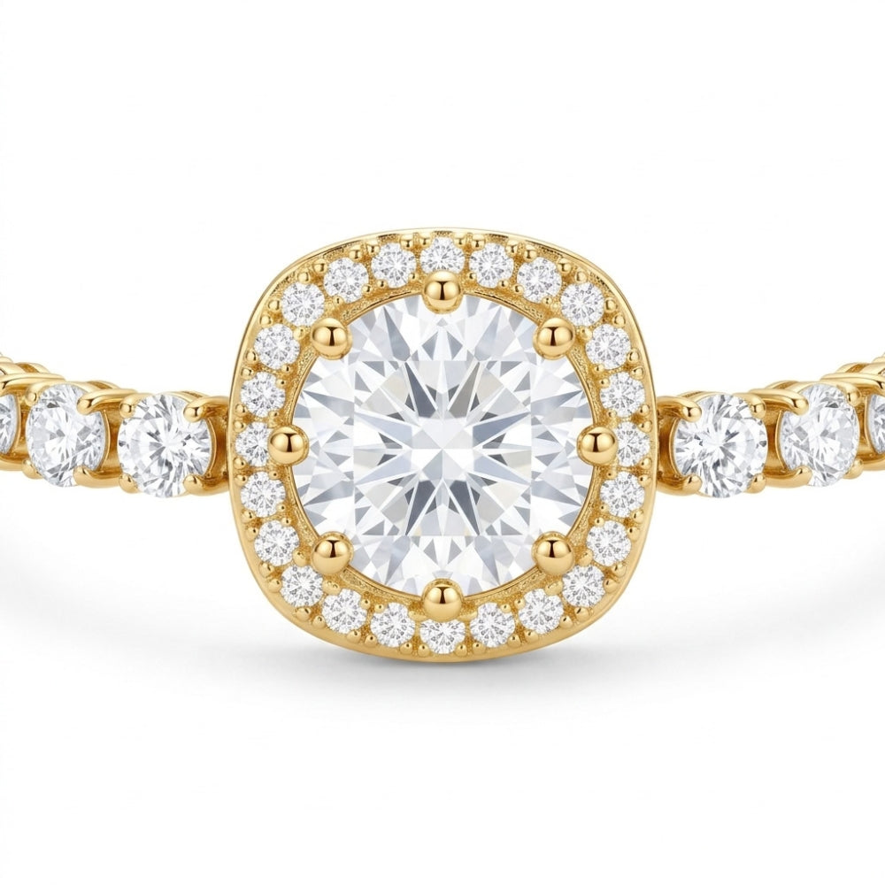 A yellow gold halo ring featuring a cushion-cut center diamond surrounded by a halo of smaller round diamonds, with a diamond-set band extending to the sides, shown on a white background.