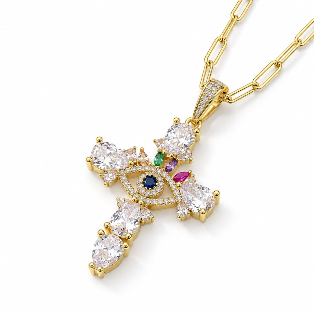 Angled close-up of the gold-tone evil eye cross pendant with clear stones and green, purple and pink accents.