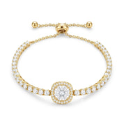 A yellow gold bracelet featuring a central round-cut diamond surrounded by a halo, with a row of pavé-set diamonds along the band and an adjustable sliding clasp, shown on a plain white background.